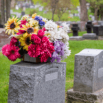 grave stone with flowers on top of it