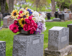 grave stone with flowers on top of it