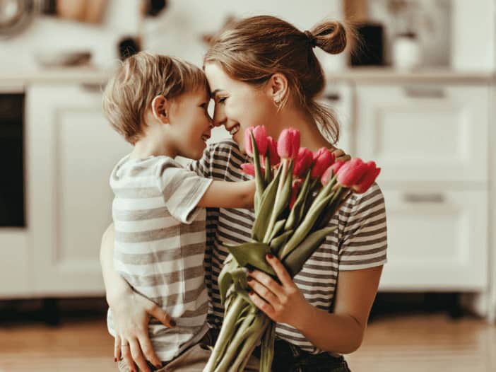 child and mother with flowers