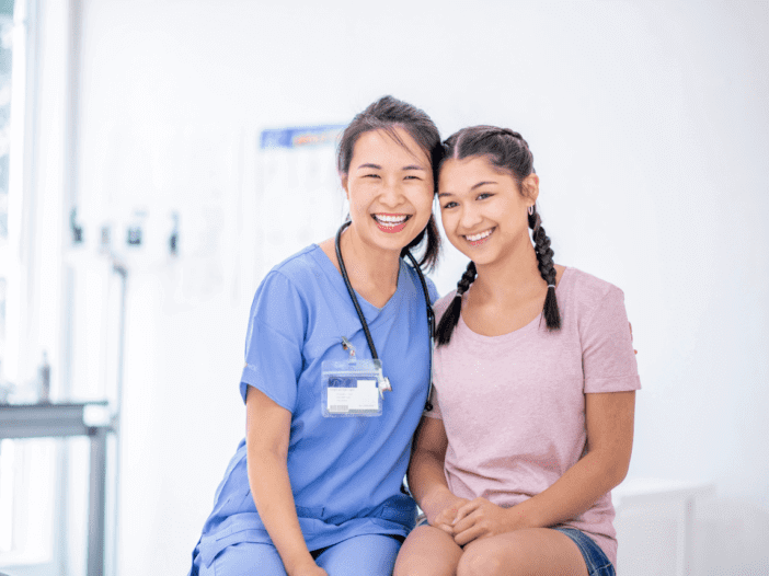 teenage girl at the doctors office with female doctor