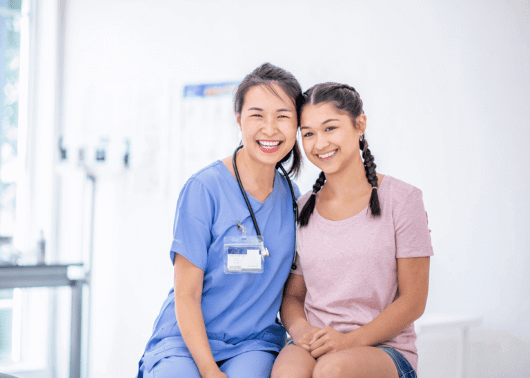 teenage girl at the doctors office with female doctor