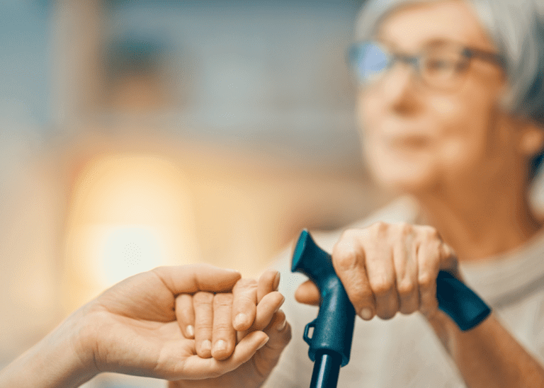 Elderly woman holding a can and holding on to another person's hand