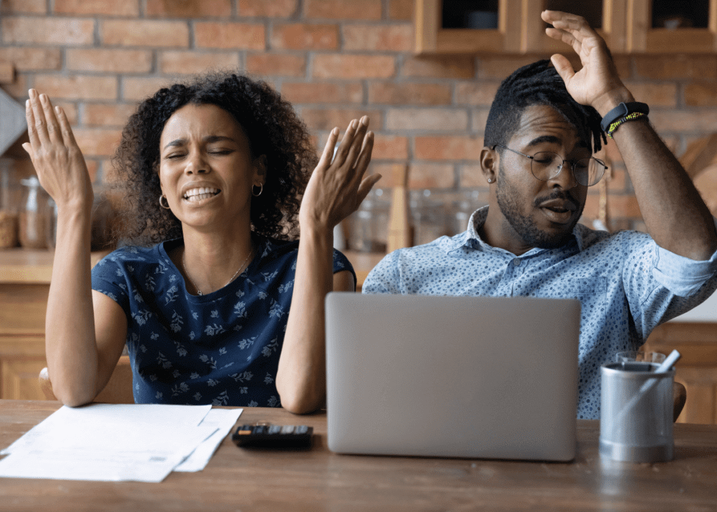couple looking at documents confused
