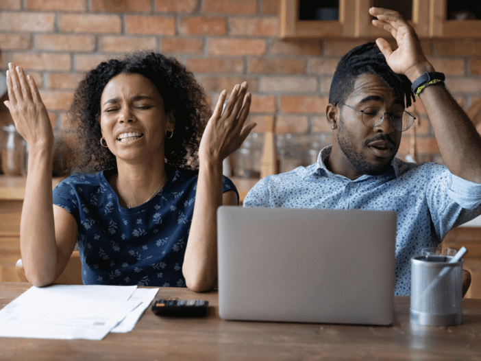 couple looking at documents confused