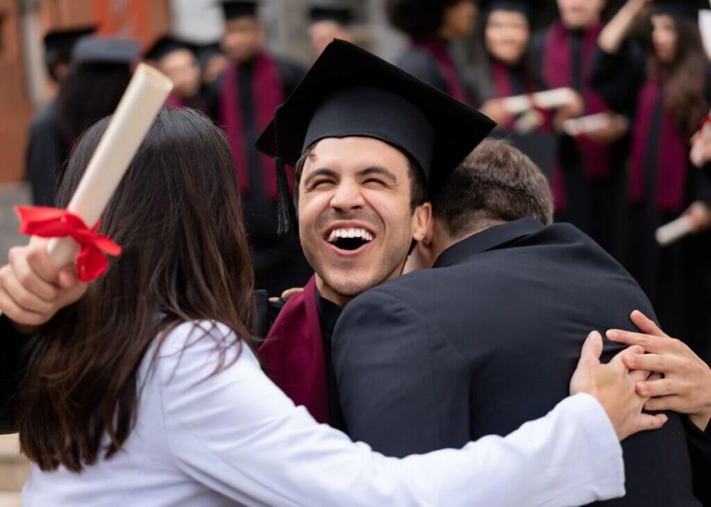 college graduate hugging parents