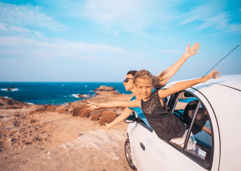 family on a roadtrip sticking their heads outside the car window