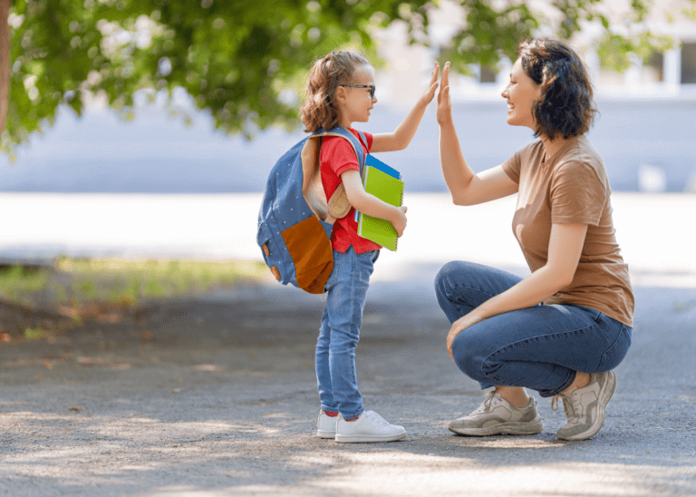 child ready for school giving mom a high five