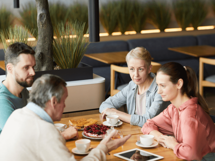 parents talking with their adult children over a meal