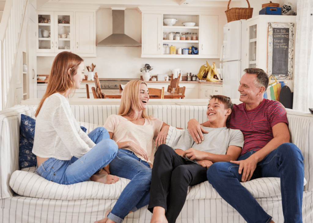 family with 18-year-old children sitting on couch