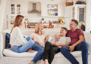 family with 18-year-old children sitting on couch