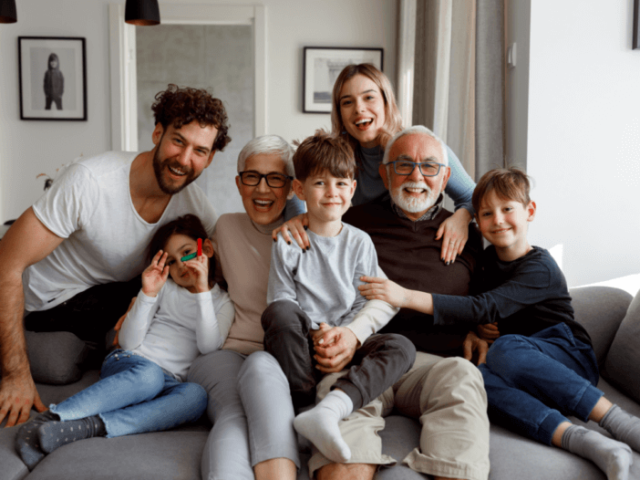 family sitting on couch snuggled together