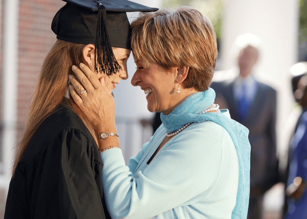 mother hugging young adult daughter