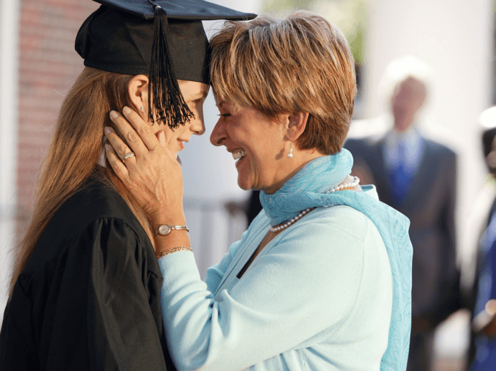 mother hugging young adult daughter