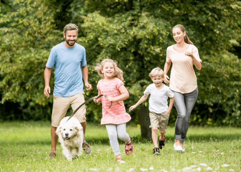 family running through spring field