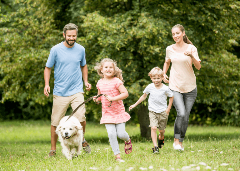 family running through spring field