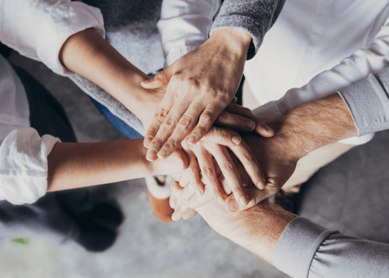 family members with hands in a circle supporting eachother