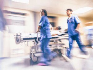 emergency room trauma team running with gurney