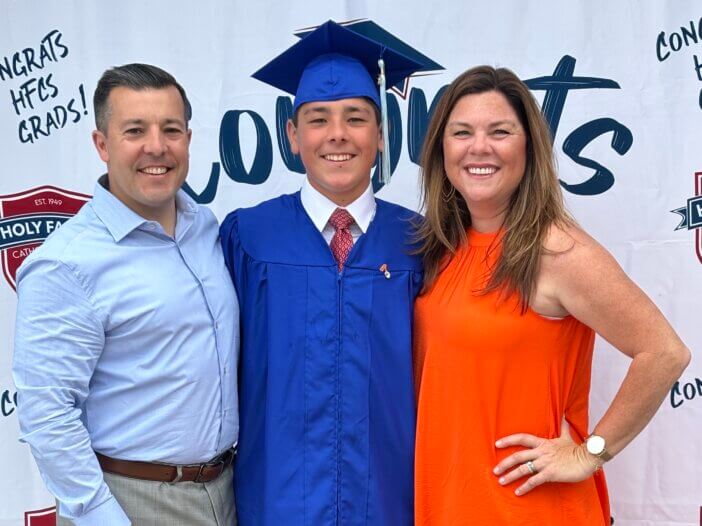 Son with parents celebrating graduation