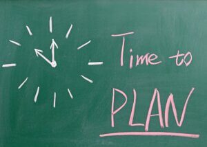 a picture of a chalkboard with a drawing of a clock and next to it says time to plan
