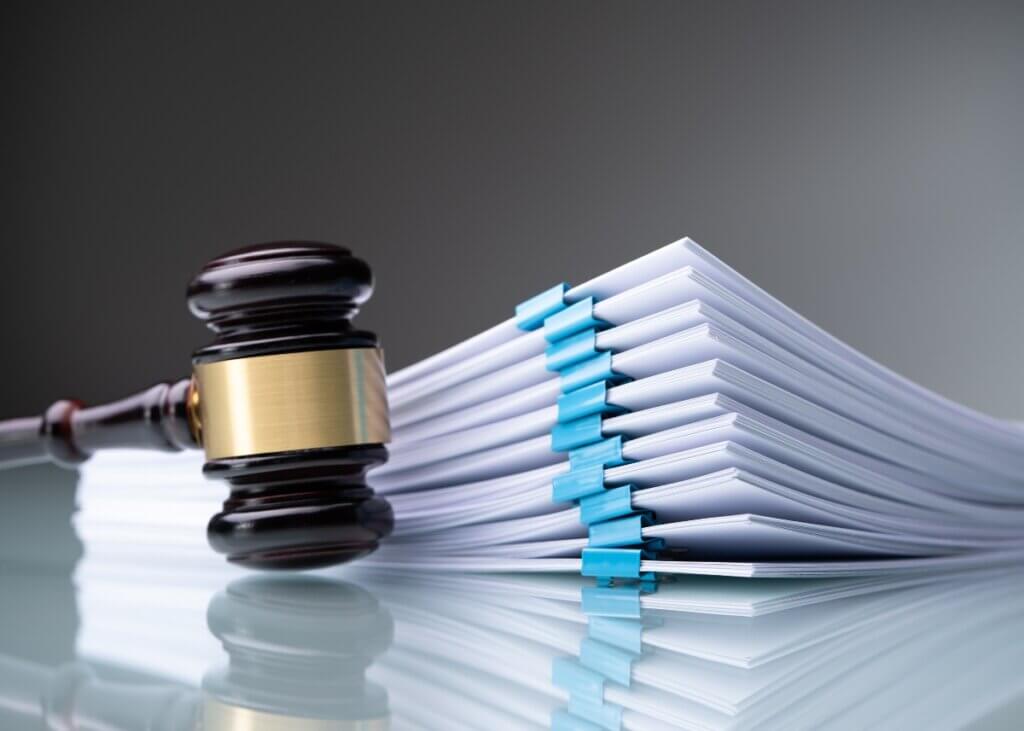 a gavel next to a stack of court papers