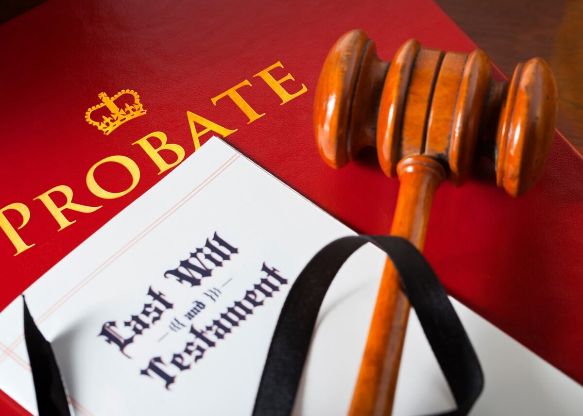 a folder titled probate with a last will and testament on top of it along with a gavel.
