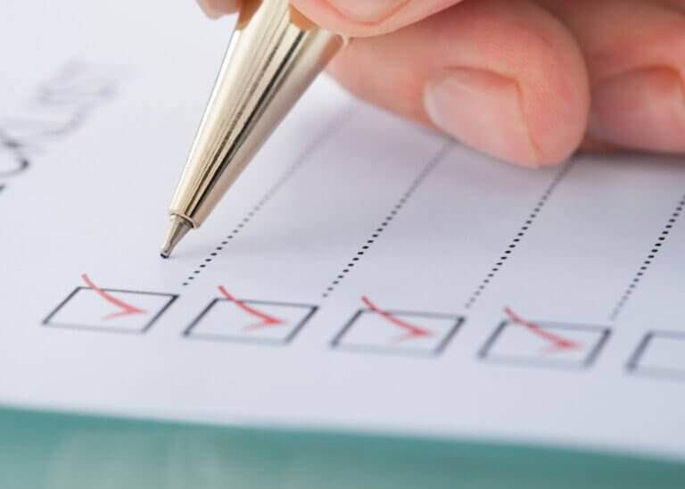 a checklist and a pen marking off the boxes with a check mark