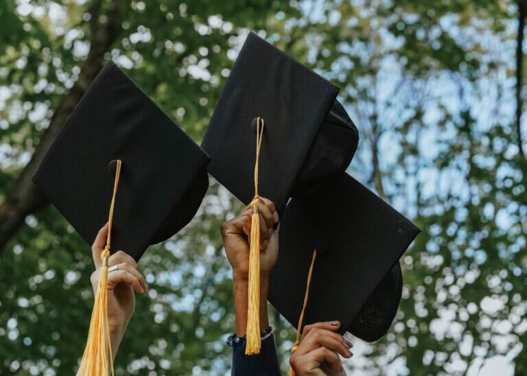 a picture of graduation caps in the air