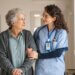 a nurse and patient in a nursing home walking down the hallway