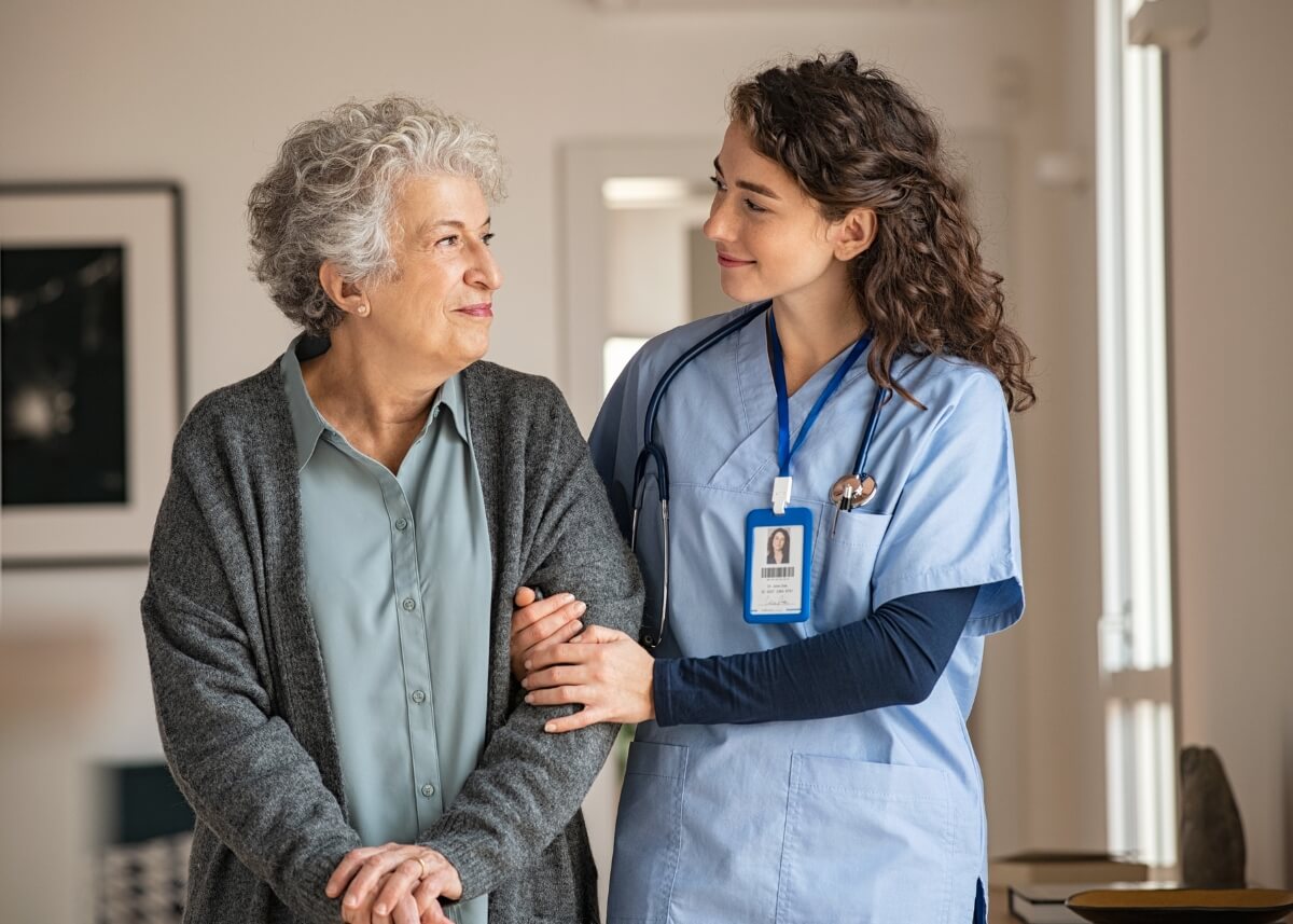 a nurse and patient in a nursing home walking down the hallway