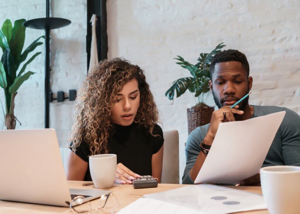 a couple working together on their business and reviewing paperwork.