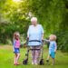 a grandmother walking on her walker with her grandkids on each side of her