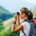 a person on vacation with their binoculars looking out at the scenery.