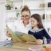 a mom with her daughter reading her a book