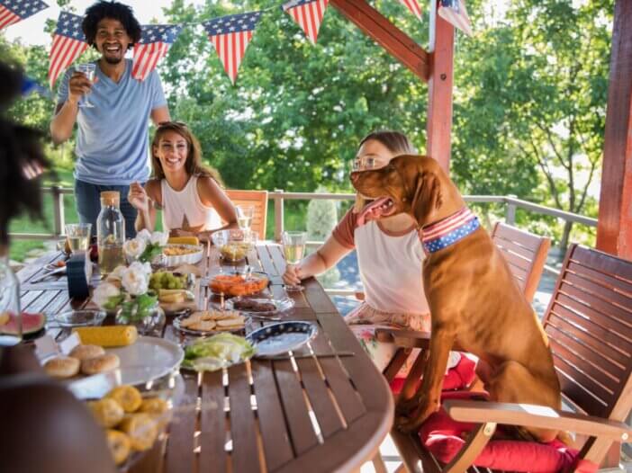 a family sitting around the table for the fourth of july eating food