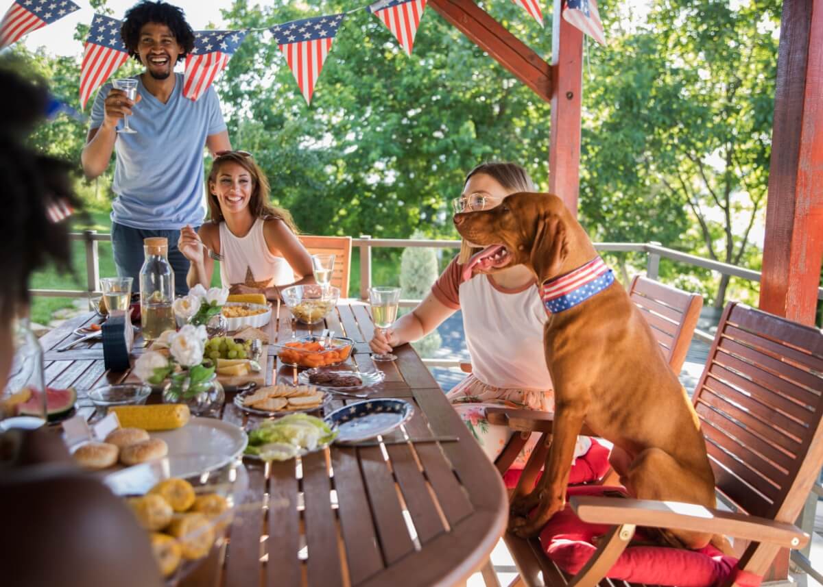 a family sitting around the table for the fourth of july eating food