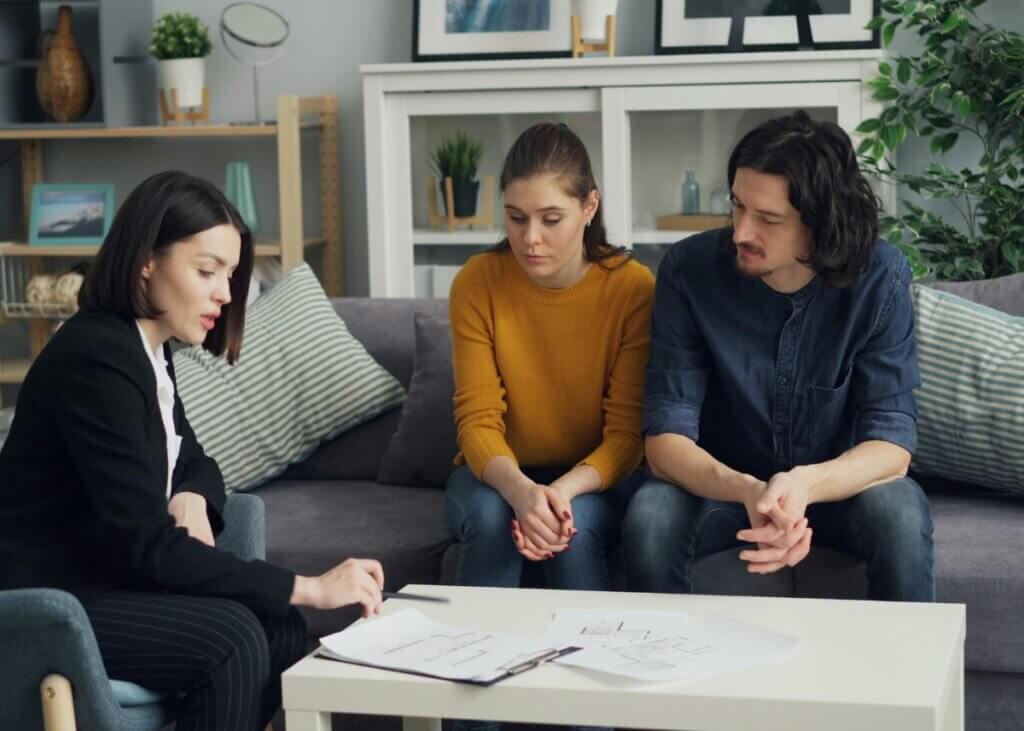 a couple with their attorney with their estate plan