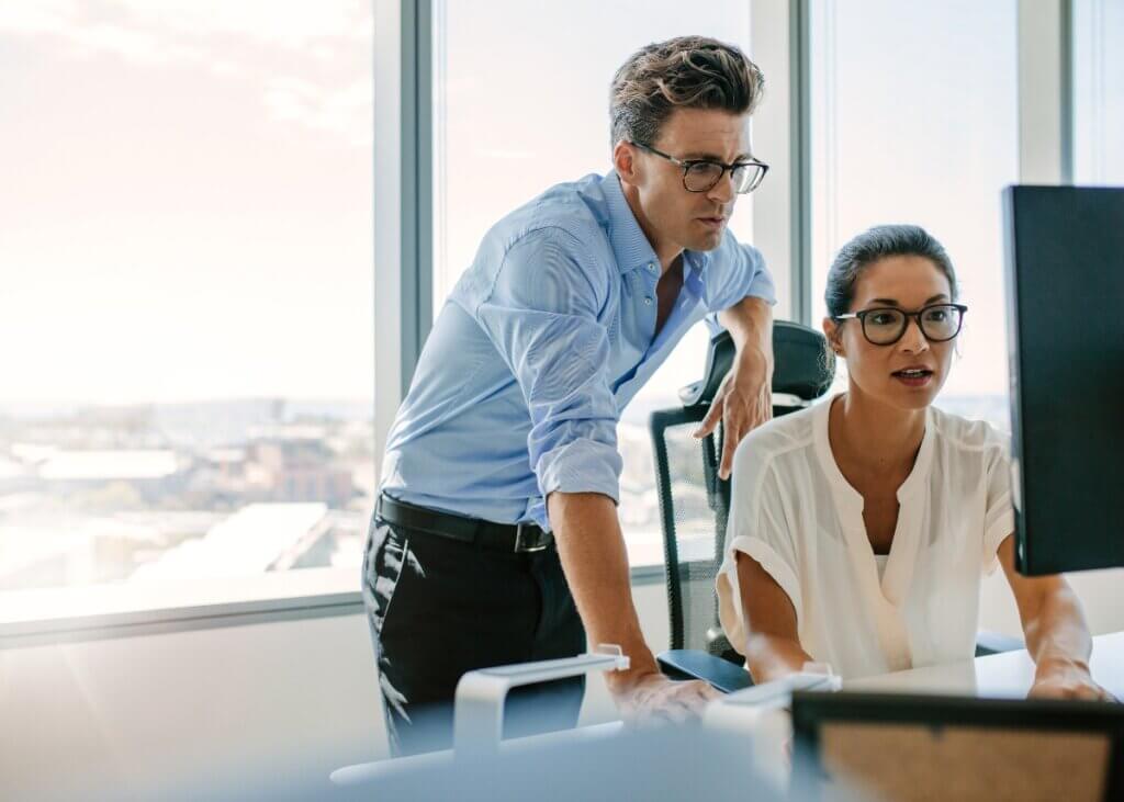 professionals discussing at a woman's computer