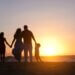 a family on the beach watching the sunset