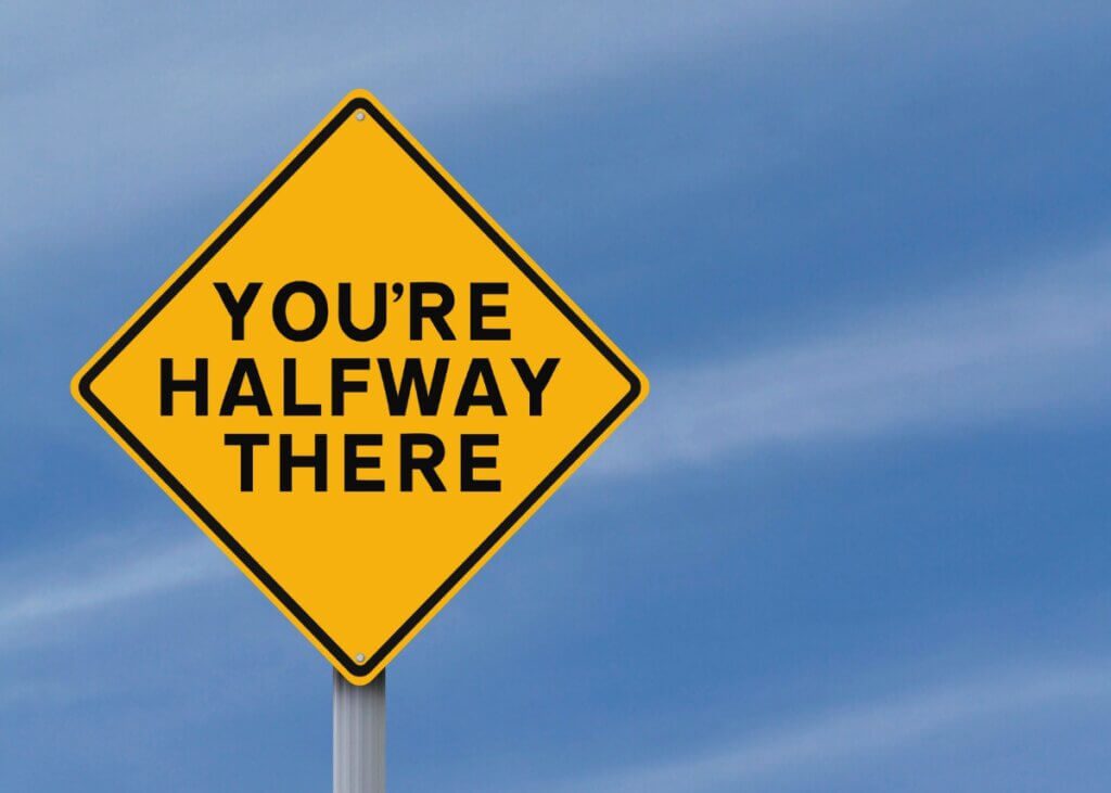 a road sign that says you're halfway there