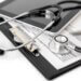 a healthcare clipboard with a patients files and a stethoscope on top