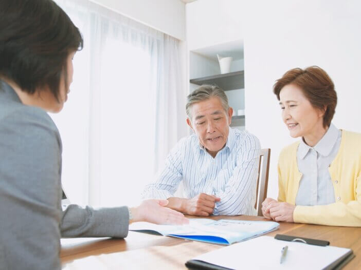 an older couple sitting with their lawyer discussing their trust