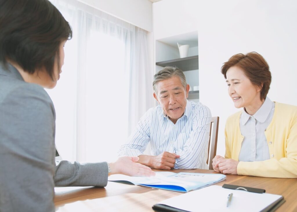 an older couple sitting with their lawyer discussing their trust