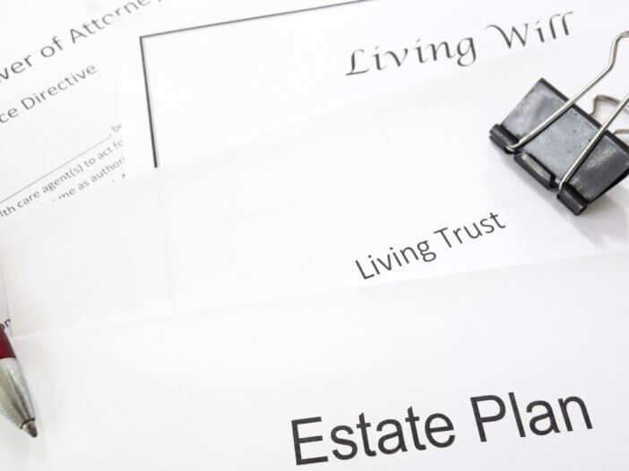 a picture of documents titled: living will, living trust, and estate plan