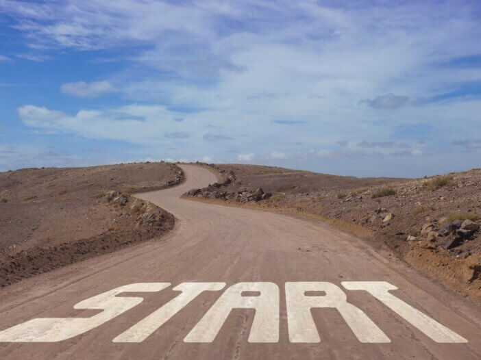 a windy dirt road that has the word start drawn into it at the beginning