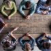 children sitting at a table strategizing
