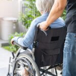 a caregiver wheeling her patient