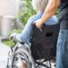 a caregiver wheeling her patient