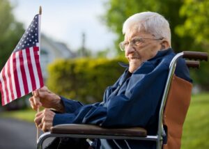 a veteran on a wheelchair holding an american flag