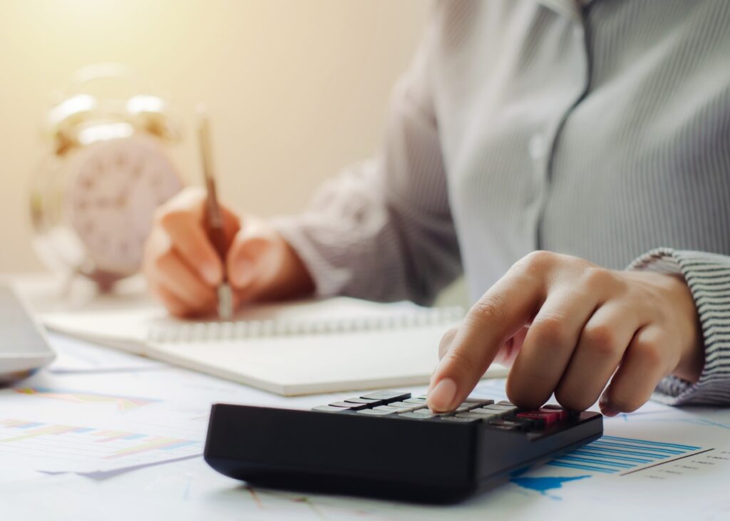 a person on a calculator who is doing their tax deductions