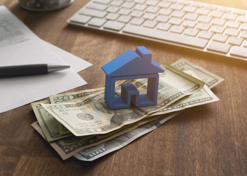 a house on a stack of cash